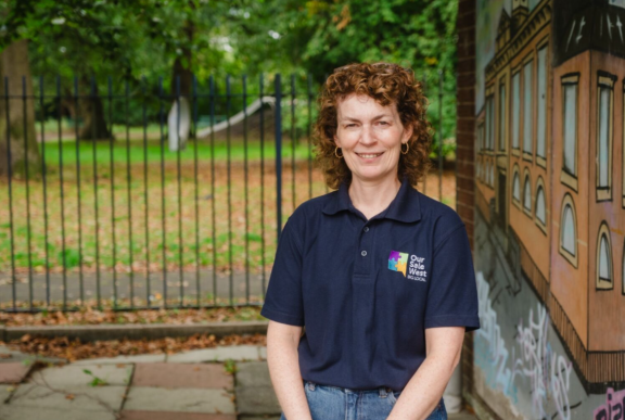 Woman in foreground of photo wearing navy blue polo shirt
