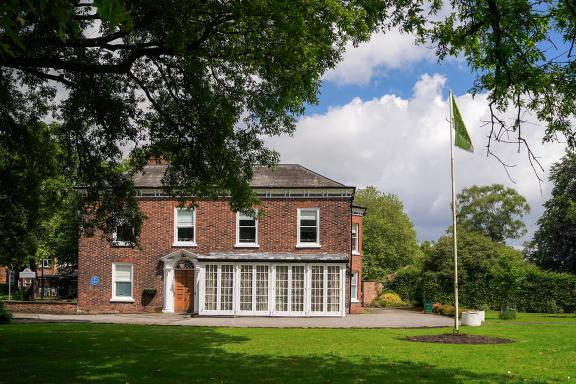 Flixton House, a Georgian brick building, appears betwen some trees