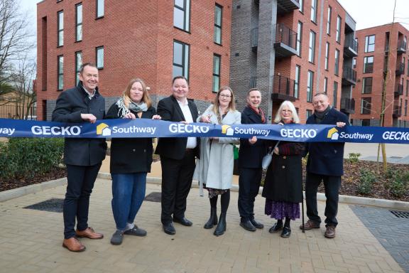 Line up of Councillors and VIPs outside new affordable homes in Old Trafford