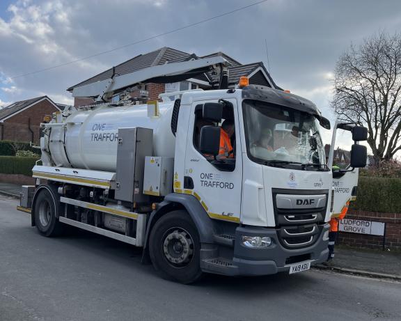 One Trafford gully‑cleaning vehicle parked on a residential street during maintenance work