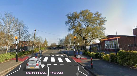 Visualisation of a proposed zebra crossing outside Partington Central Academy. The image shows a road with a new zebra crossing, Belisha beacons, tactile paving and updated road markings.