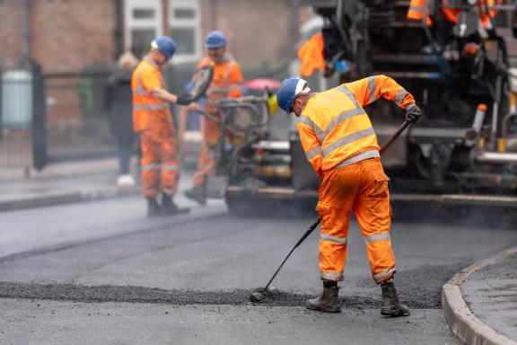 Workers fixing pot holes