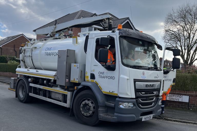 One Trafford gully‑cleaning vehicle parked on a residential street during maintenance work
