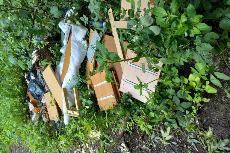 furniture which has been dumped onto a green area